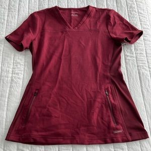 Women’s Jaanuu 2 pocket maroon scrub top. Size Small